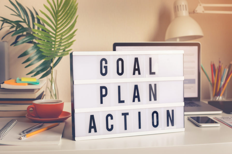Goal,plan,action text on light box on desk table in home office