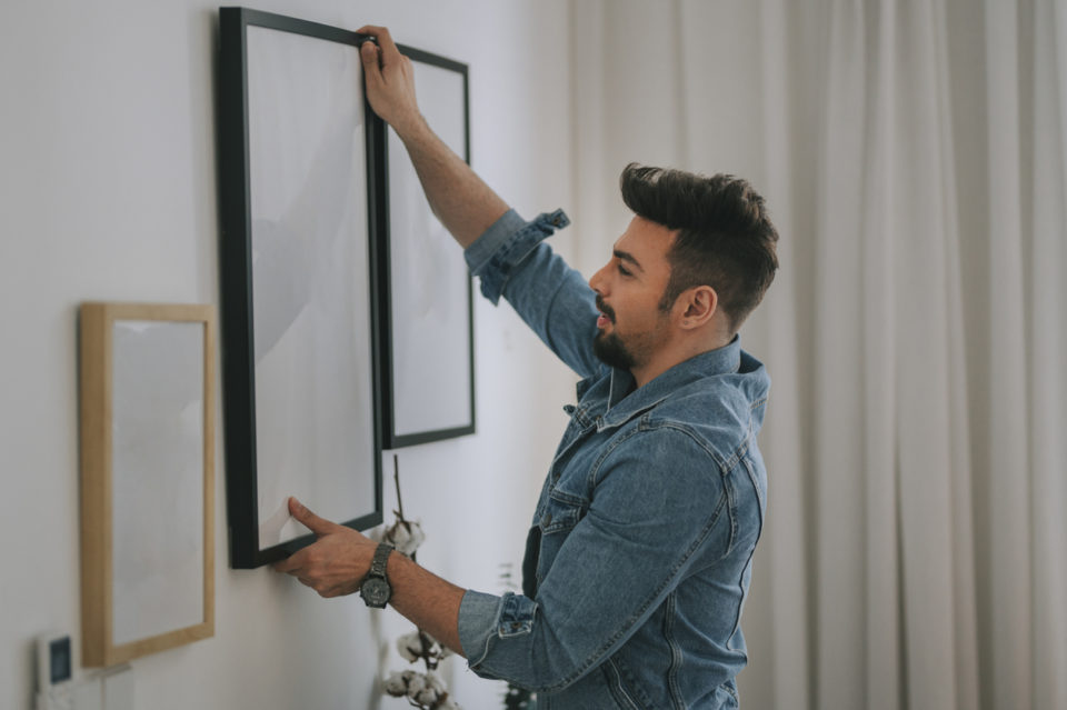 Man hanging pictures