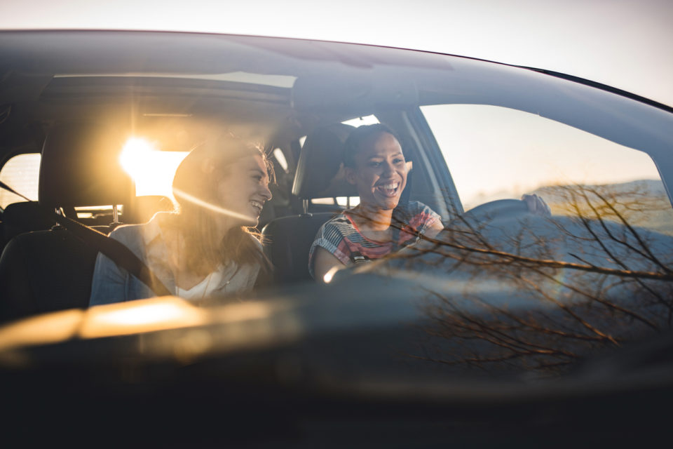 Young friends driving through countryside.