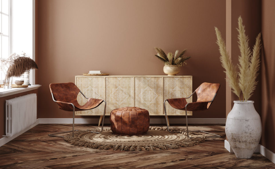 Home interior with ethnic boho decoration, living room in brown warm color