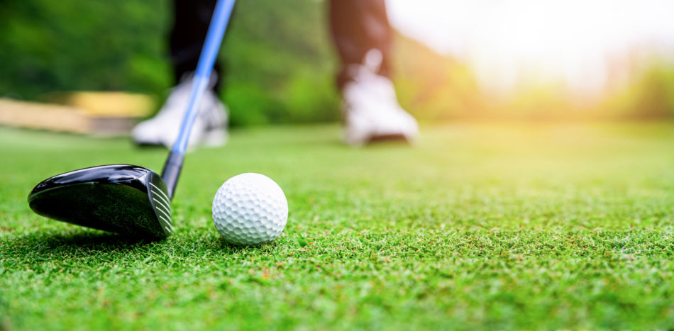 Close up of golf club hitting golf ball