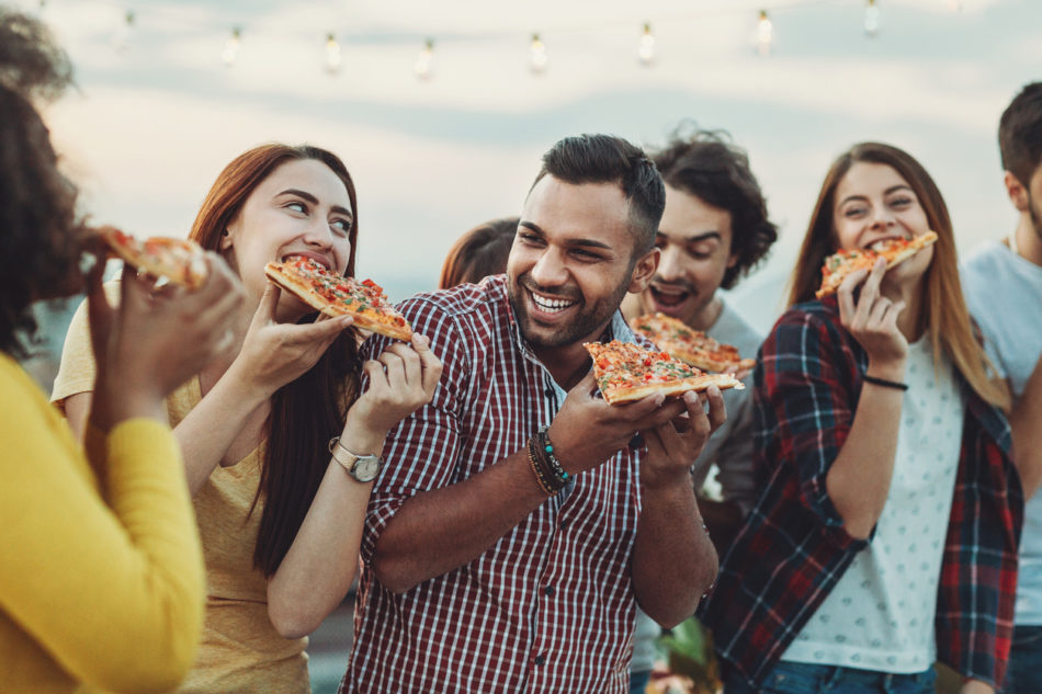 Group of friends eating pizza