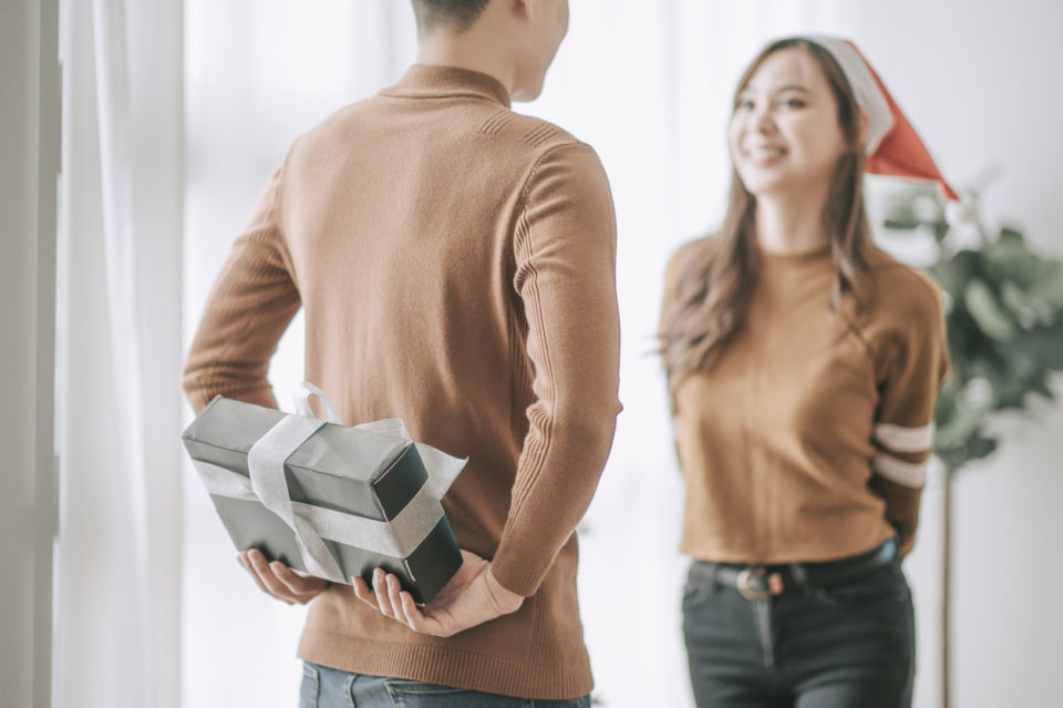 young couple celebrating christmas season at home living room