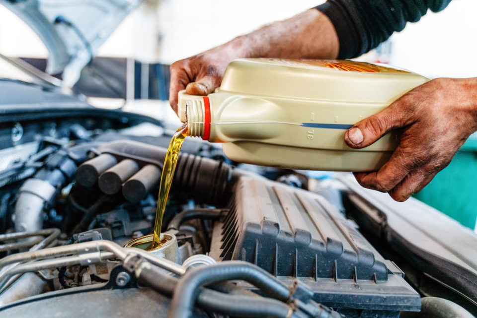 pouring fresh oil into engine