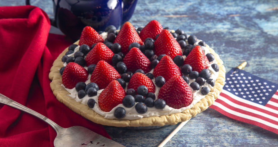 Strawberry and Blueberry Fresh Summer Pie on a Distressed Blue Wooden Table