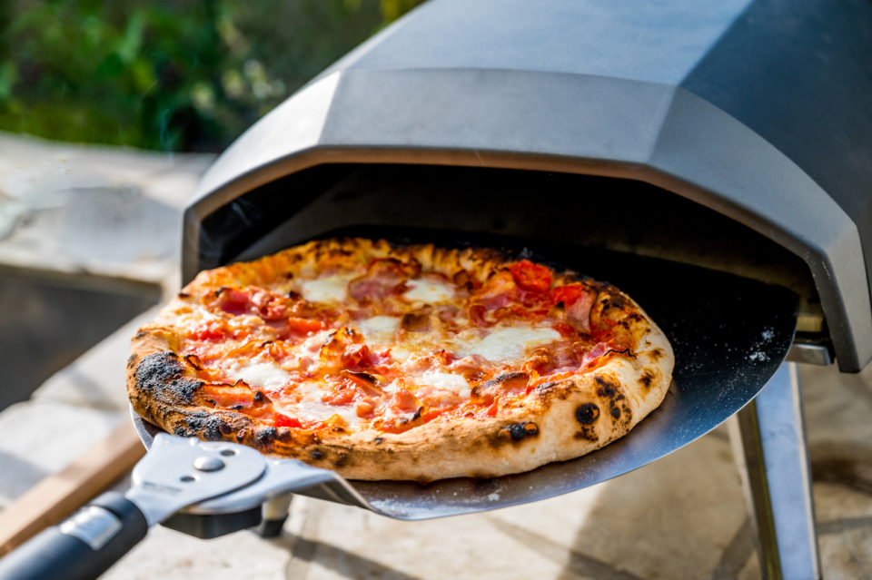 Making home made pizza in portable high temperature pizza oven.