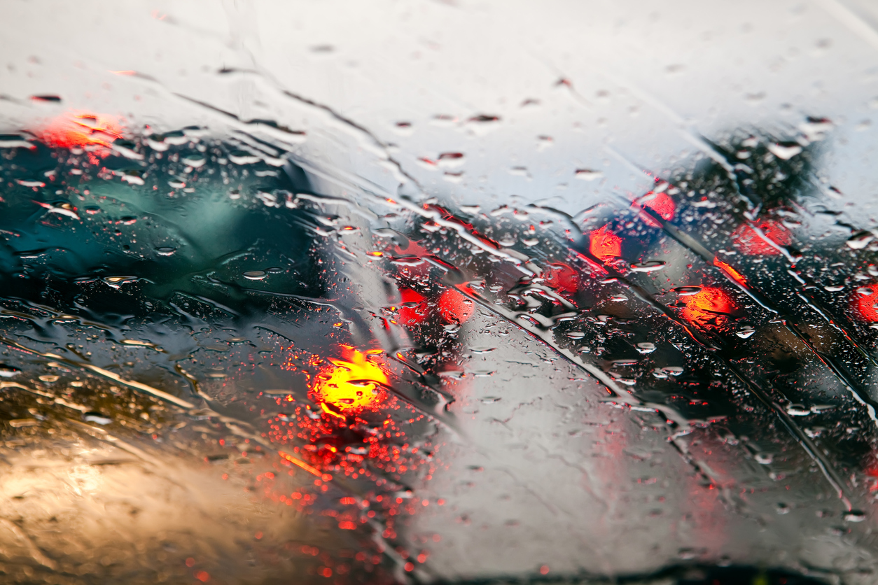 Car windshield in traffic jam during rain