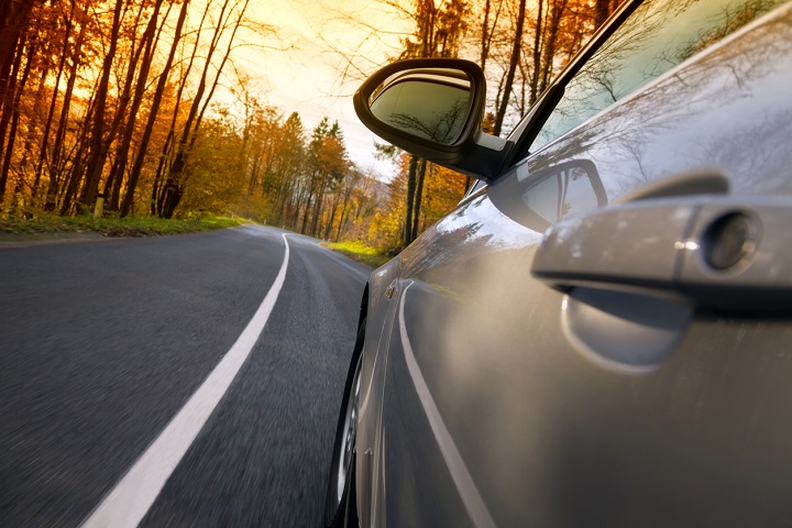 Car crossing a country road.