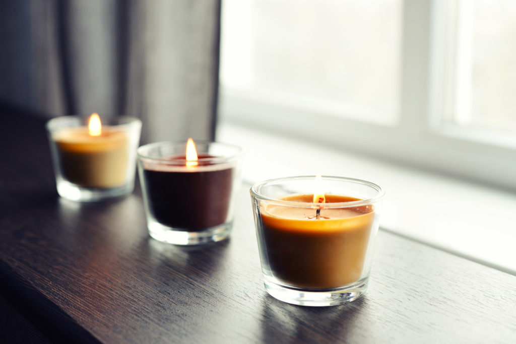 Cozy candles on a wooden table