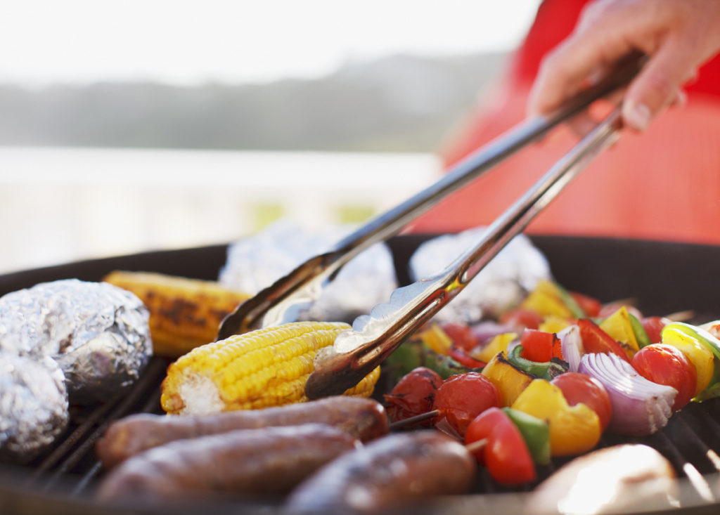 man grilling food on barbecue grill