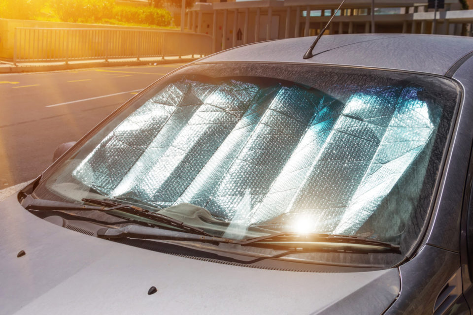 car with sun visor in windshield to keep cool